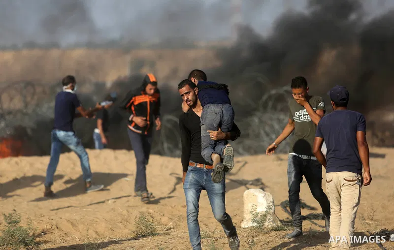 Palestinian protesters gather during clashes with Israeli troops in tents protest where Palestinian demand the right to return to their homeland at the Israel-Gaza border, in Khan Younis in the southern Gaza Strip on Jul...