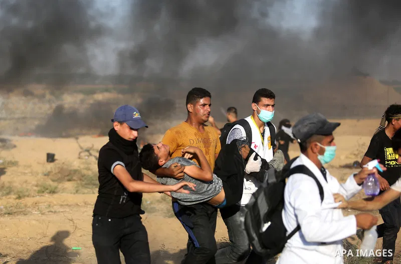Palestinian protesters gather during clashes with Israeli troops in tents protest where Palestinian demand the right to return to their homeland at the Israel-Gaza border, in Khan Younis in the southern Gaza Strip on Jul...