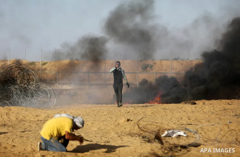 Palestinian protesters gather during clashes with Israeli troops in tents protest where Palestinian demand the right to return to their homeland at the Israel-Gaza border, in Khan Younis in the southern Gaza Strip on Jul...