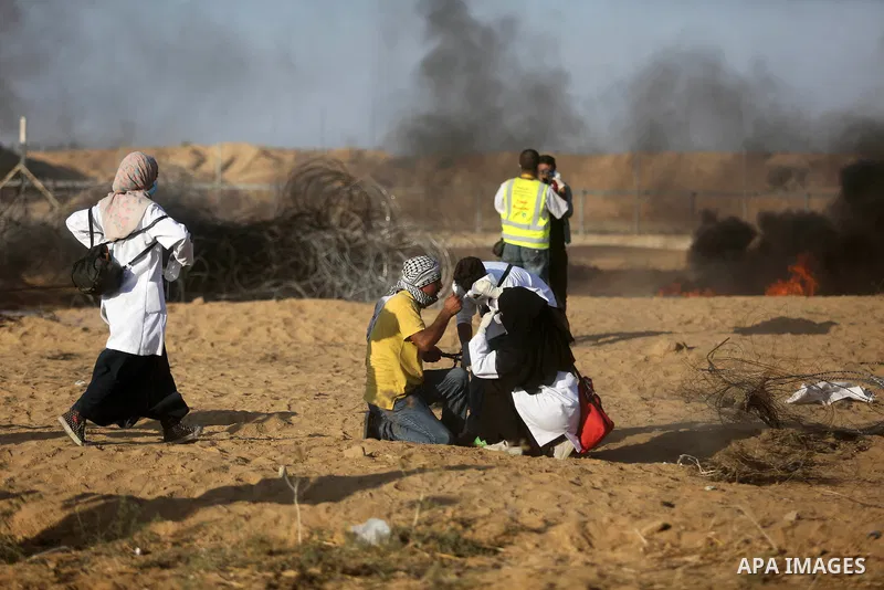 Palestinian protesters gather during clashes with Israeli troops in tents protest where Palestinian demand the right to return to their homeland at the Israel-Gaza border, in Khan Younis in the southern Gaza Strip on Jul...