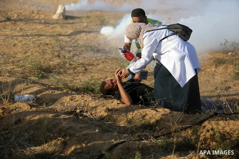 Palestinian protesters gather during clashes with Israeli troops in tents protest where Palestinian demand the right to return to their homeland at the Israel-Gaza border, in Khan Younis in the southern Gaza Strip on Jul...