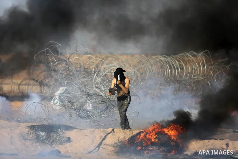 Palestinian protesters gather during clashes with Israeli troops in tents protest where Palestinian demand the right to return to their homeland at the Israel-Gaza border, in Khan Younis in the southern Gaza Strip on Jul...