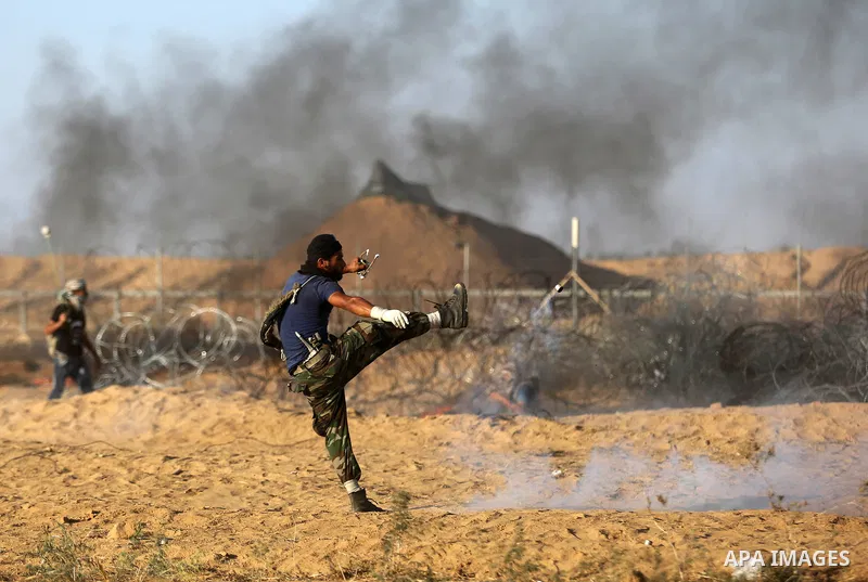 Palestinian protesters gather during clashes with Israeli troops in tents protest where Palestinian demand the right to return to their homeland at the Israel-Gaza border, in Khan Younis in the southern Gaza Strip on Jul...