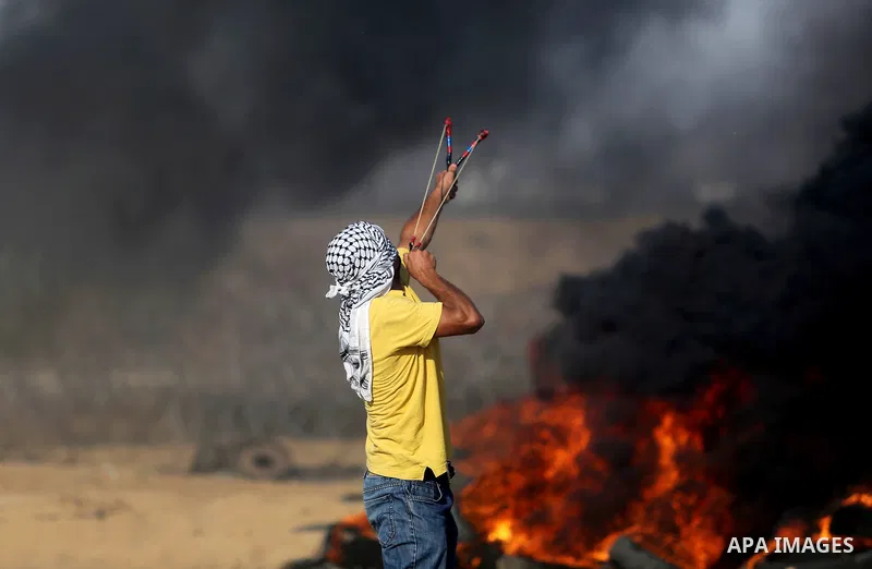 Palestinian protesters gather during clashes with Israeli troops in tents protest where Palestinian demand the right to return to their homeland at the Israel-Gaza border, in Khan Younis in the southern Gaza Strip on Jul...