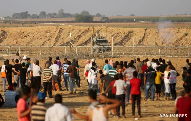 Palestinian protesters gather during clashes with Israeli troops in tents protest where Palestinian demand the right to return to their homeland at the Israel-Gaza border, in Khan Younis in the southern Gaza Strip on Jul...