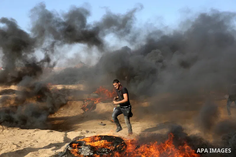Palestinian protesters gather during clashes with Israeli troops in tents protest where Palestinian demand the right to return to their homeland at the Israel-Gaza border, in Khan Younis in the southern Gaza Strip on Jul...