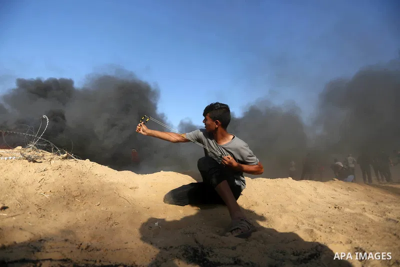 Palestinian protesters gather during clashes with Israeli troops in tents protest where Palestinian demand the right to return to their homeland at the Israel-Gaza border, in Khan Younis in the southern Gaza Strip on Jul...