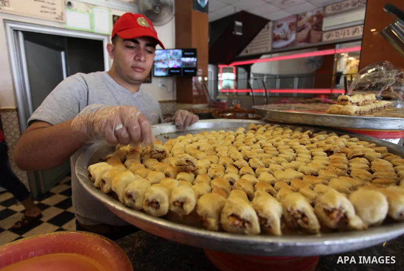 A Palestinian vendor displays sweets ahead the results of high school exams, known as ''Tawjihi'', in Gaza city, on July 8, 2018. Photo by Mahmoud Ajour