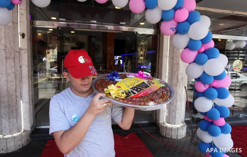 A Palestinian vendor displays sweets ahead the results of high school exams, known as ''Tawjihi'', in Gaza city, on July 8, 2018. Photo by Mahmoud Ajour