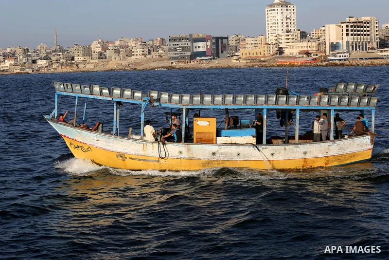 Palestinian fishermen ride their fishing boat off the coast of Gaza City on July 9, 2018. Israel have reduced the fishing zone for Gaza's fishermen from nine miles to six nautical miles in response to the continued launc...