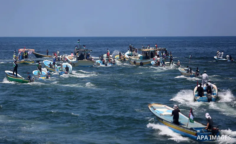 Palestinian activists ride fishing boats sails towards Europe aiming to break Israel's blockade on Gaza, at the sea in Gaza, on July 10, 2018. The Gaza Strip has been under Israeli blockade since 2007. Photo by Ashraf Am...