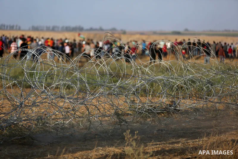 Palestinian protesters gather during clashes with Israeli troops in tents protest where Palestinian demand the right to return to their homeland at the Israel-Gaza border, in Khan Younis, in the southern Gaza Strip on Ju...