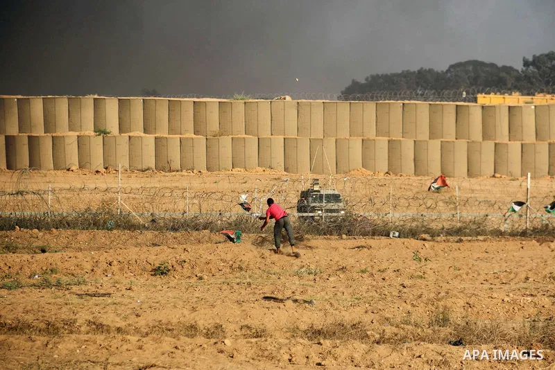 Palestinian protesters gather during clashes with Israeli troops in tents protest where Palestinian demand the right to return to their homeland at the Israel-Gaza border, in al-Bureij in the center of Gaza Strip on July...