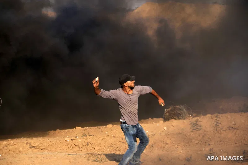 Palestinian protesters gather during clashes with Israeli troops in tents protest where Palestinian demand the right to return to their homeland at the Israel-Gaza border, in al-Bureij in the center of Gaza Strip on July...