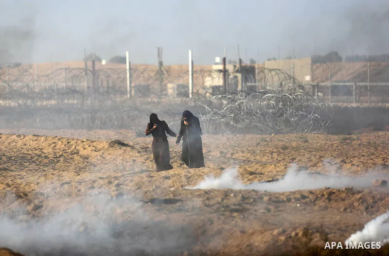 Palestinian protesters gather during clashes with Israeli troops in tents protest where Palestinian demand the right to return to their homeland at the Israel-Gaza border, in Khan Younis, in the southern Gaza Strip on Ju...