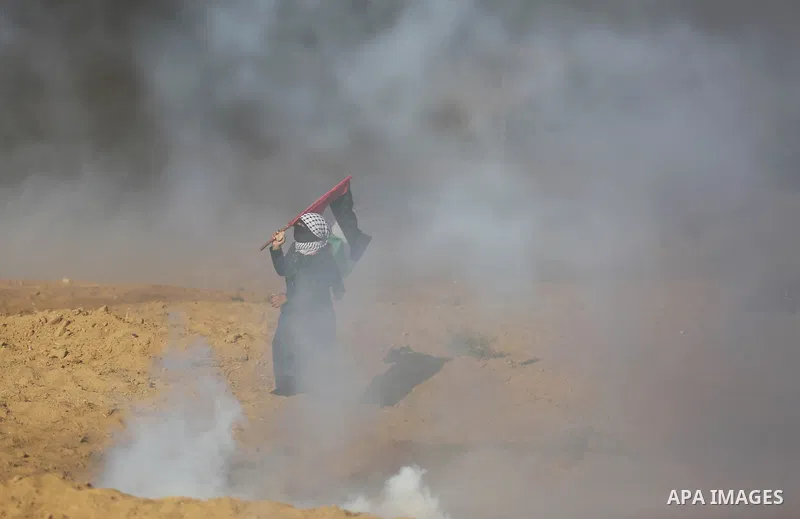 Palestinian protesters gather during clashes with Israeli troops in tents protest where Palestinian demand the right to return to their homeland at the Israel-Gaza border, in Khan Younis, in the southern Gaza Strip on Ju...