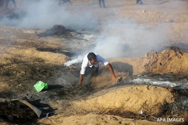Palestinian protesters gather during clashes with Israeli troops in tents protest where Palestinian demand the right to return to their homeland at the Israel-Gaza border, in Khan Younis, in the southern Gaza Strip on Ju...
