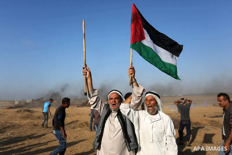 Palestinian protesters gather during clashes with Israeli troops in tents protest where Palestinian demand the right to return to their homeland at the Israel-Gaza border, in Khan Younis, in the southern Gaza Strip on Ju...