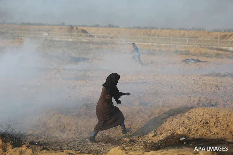 Palestinian protesters gather during clashes with Israeli troops in tents protest where Palestinian demand the right to return to their homeland at the Israel-Gaza border, in Khan Younis, in the southern Gaza Strip on Ju...