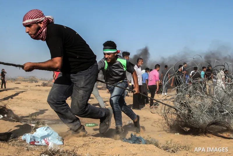 Palestinian protesters gather during clashes with Israeli troops in tents protest where Palestinian demand the right to return to their homeland at the Israel-Gaza border, in Rafah in the southern Gaza Strip on July 13,...