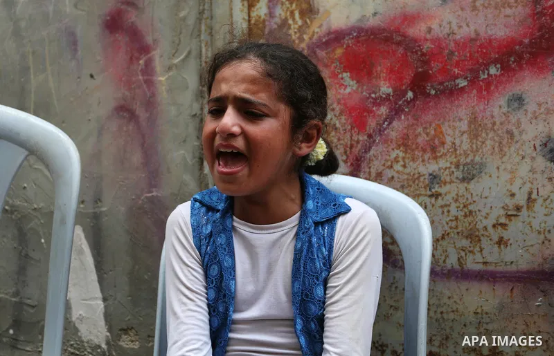 A relative of Palestinian Nasser Shurrab,18, who was shot dead by Israeli troops during clashes at Gaza-Israel border, mourns during his funeral in Khan Younis in the southern Gaza Strip July 14, 2018. Photo by Ashraf Am...