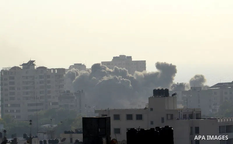 Smoke raises above buildings during an Israeli air strike on Gaza City on July 14, 2018. Israel's military renewed air strikes targeting Hamas in the Gaza Strip today, following border clashes in which two Palestinians i...