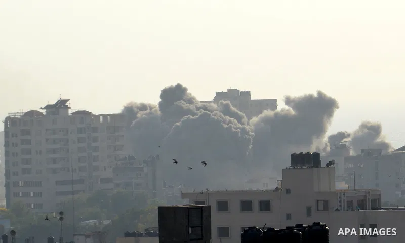 Smoke raises above buildings during an Israeli air strike on Gaza City on July 14, 2018. Israel's military renewed air strikes targeting Hamas in the Gaza Strip today, following border clashes in which two Palestinians i...