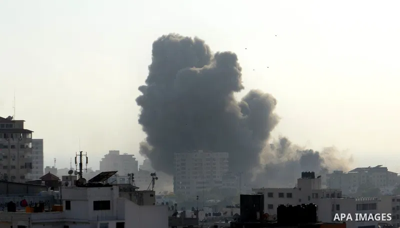 Smoke raises above buildings during an Israeli air strike on Gaza City on July 14, 2018. Israel's military renewed air strikes targeting Hamas in the Gaza Strip today, following border clashes in which two Palestinians i...