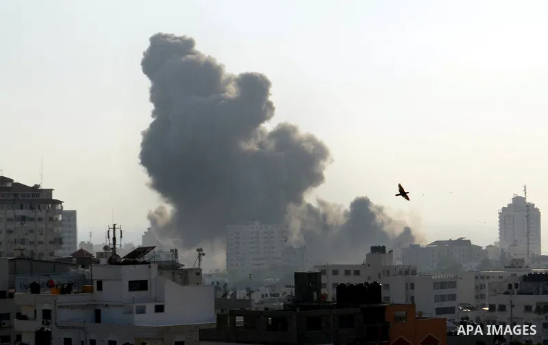 Smoke raises above buildings during an Israeli air strike on Gaza City on July 14, 2018. Israel's military renewed air strikes targeting Hamas in the Gaza Strip today, following border clashes in which two Palestinians i...