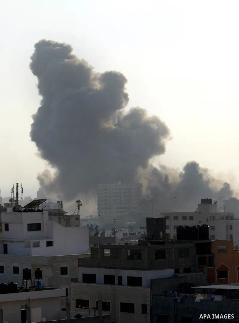 Smoke raises above buildings during an Israeli air strike on Gaza City on July 14, 2018. Israel's military renewed air strikes targeting Hamas in the Gaza Strip today, following border clashes in which two Palestinians i...