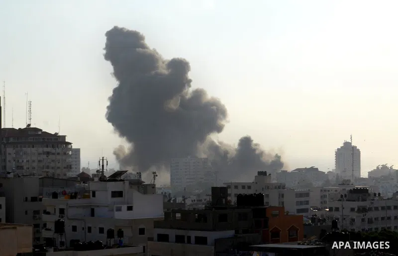 Smoke raises above buildings during an Israeli air strike on Gaza City on July 14, 2018. Israel's military renewed air strikes targeting Hamas in the Gaza Strip today, following border clashes in which two Palestinians i...
