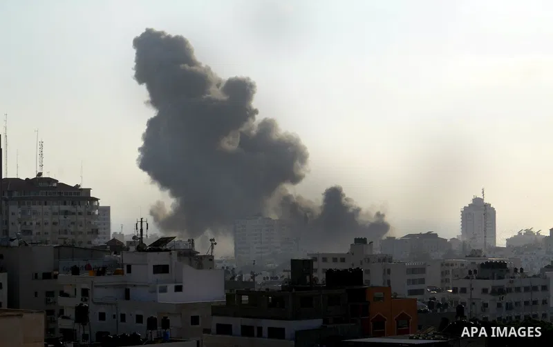 Smoke raises above buildings during an Israeli air strike on Gaza City on July 14, 2018. Israel's military renewed air strikes targeting Hamas in the Gaza Strip today, following border clashes in which two Palestinians i...