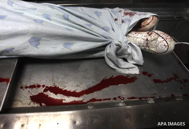 The body of 16-year-old Loay Kohail, who was killed during an Israeli air strike on Gaza city, lays at the morgue of al-Shifa hospital, 14 July 2018. At least two Palestinians were killed after an Israeli air strike on G...