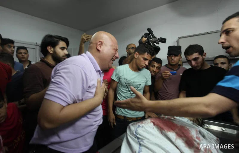 Relatives mourn over the body of 16-year-old Loay Kohail, who was killed during an Israeli air strike on Gaza city, at al-Shifa hospital, 14 July 2018. At least two Palestinians were killed after an Israeli air strike on...