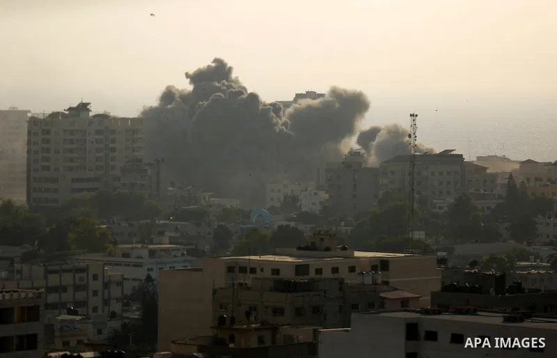 Smoke raises above buildings during an Israeli air strike on Gaza City on July 14, 2018. Israel's military renewed air strikes targeting Hamas in the Gaza Strip today, following border clashes in which two Palestinians i...