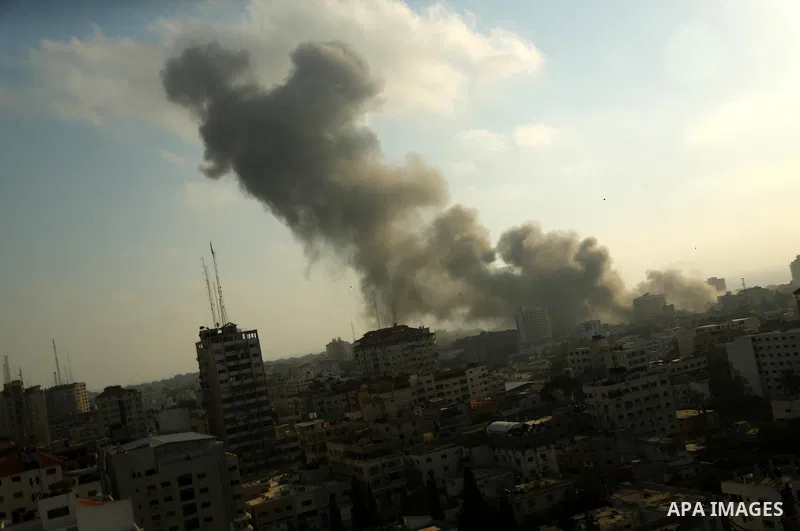 Smoke raises above buildings during an Israeli air strike on Gaza City on July 14, 2018. Israel's military renewed air strikes targeting Hamas in the Gaza Strip today, following border clashes in which two Palestinians i...