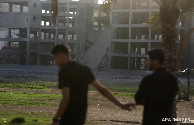 Palestinians inspect the damage after an Israeli air strik on the Gaza City, on July 14, 2018. At least two Palestinians were killed after an Israeli air strike hit an empty building in Gaza City. Photo by Ashraf Amra