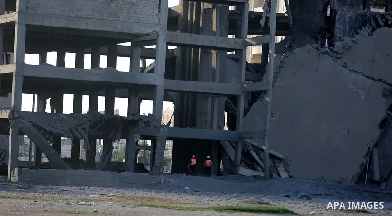 Members of the Palestinian civil defence inspect damage after an Israeli air strik on the Gaza City, on July 14, 2018. At least two Palestinians were killed after an Israeli air strike hit an empty building in Gaza City....