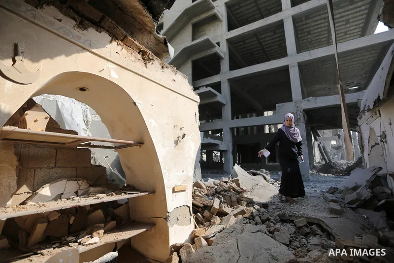 Palestinians inspect the building that was damaged in an Israeli airstrike on the Gaza City, on July 15, 2018. Israel's military said it had launched air strikes targeting Hamas in the Gaza Strip on July 14, as rockets a...