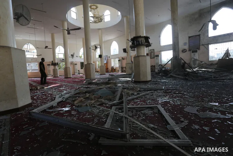 Palestinians inspect a mosque that was damaged in an Israeli airstrike on the Gaza City, on July 15, 2018. Israel's military said it had launched air strikes targeting Hamas in the Gaza Strip on July 14, as rockets and m...