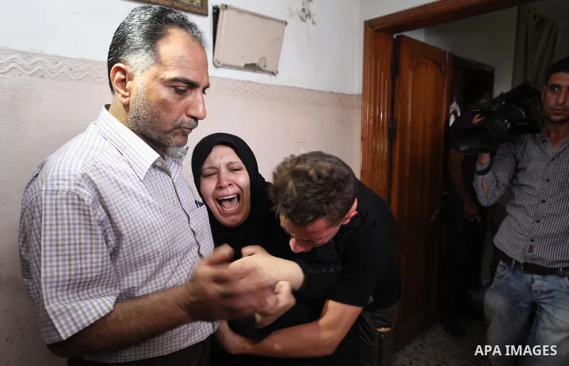Relatives of Palestinian Amir Al-Namara, who was killed in an Israeli air strike, mourn during his funeral in Gaza city on July 15, 2018. Photo by Mahmoud Ajour
