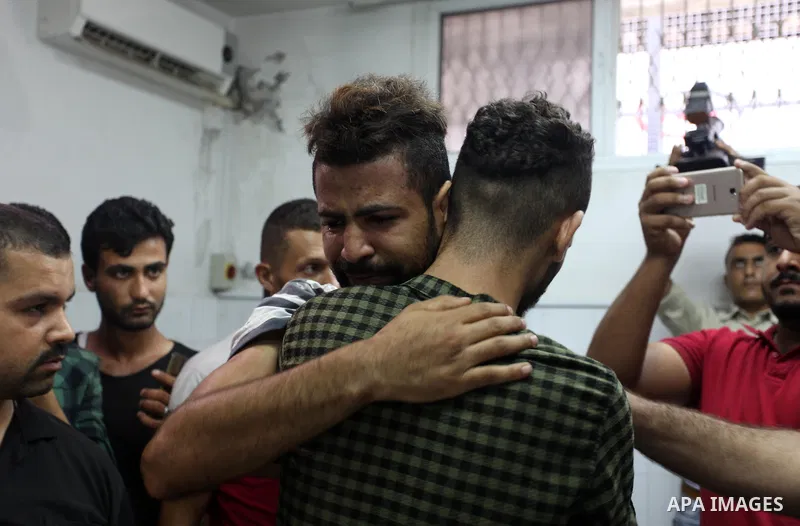 Relatives of two Palestinians who were killed in an unexplained explosion mourn at morgue in al-shifa hospital, in Gaza city on July 15, 2018. Photo by Mahmoud Ajour