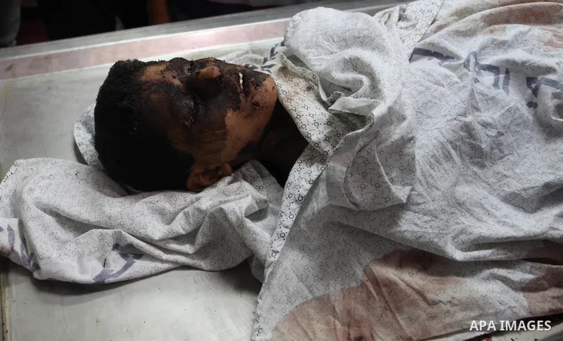 The body of Palestinian Louay Hassan, 13, who was killed in an unexplained explosion mourn at morgue in al-shifa hospital, in Gaza city on July 15, 2018. Photo by Mahmoud Ajour
