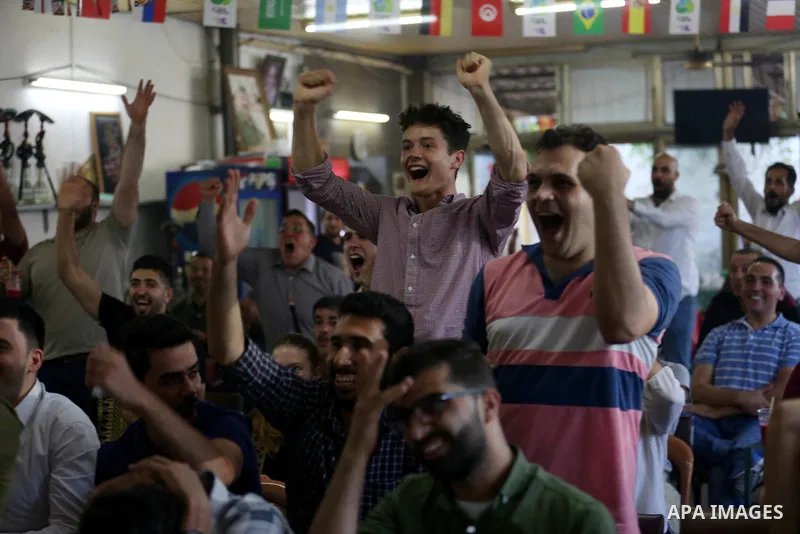 Palestinians watch on a screen the Russia 2018 World Cup final football match between France and Croatia, in the West Bank city of Nablus on July 15, 2018. Photo by Shadi Jarar'ah