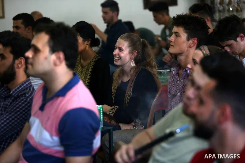 Palestinians watch on a screen the Russia 2018 World Cup final football match between France and Croatia, in the West Bank city of Nablus on July 15, 2018. Photo by Shadi Jarar'ah