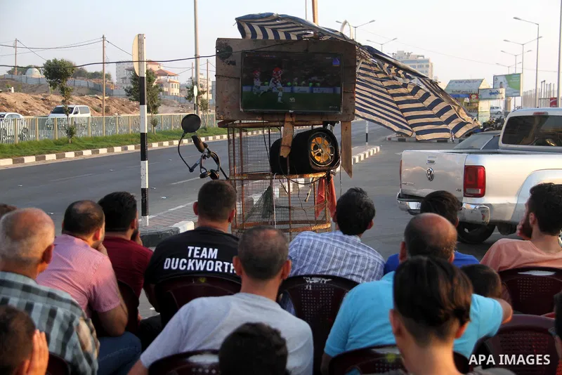 Palestinians watch on a screen the Russia 2018 World Cup final football match between France and Croatia, in Gaza city, on July 15, 2018. France defeated Croatia 4-2 and claimed the title. Photo by Mahmoud Ajour