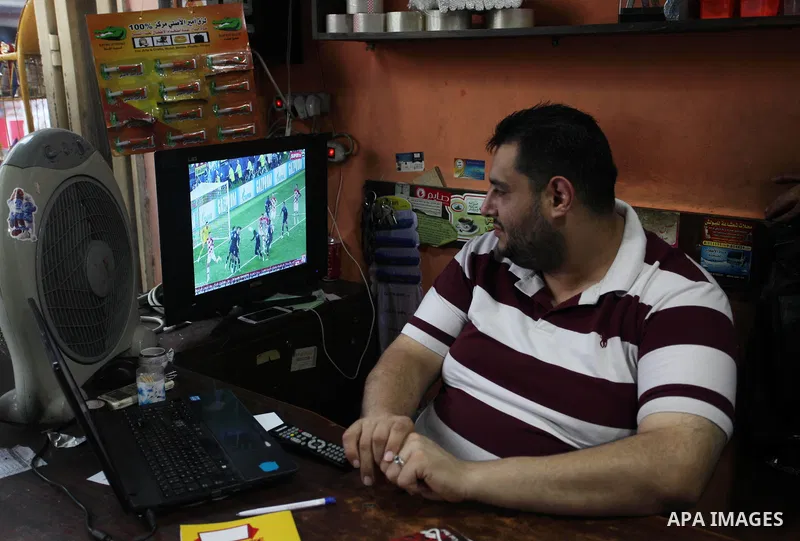 Palestinians watch on a screen the Russia 2018 World Cup final football match between France and Croatia, in Gaza city, on July 15, 2018. France defeated Croatia 4-2 and claimed the title. Photo by Mahmoud Ajour