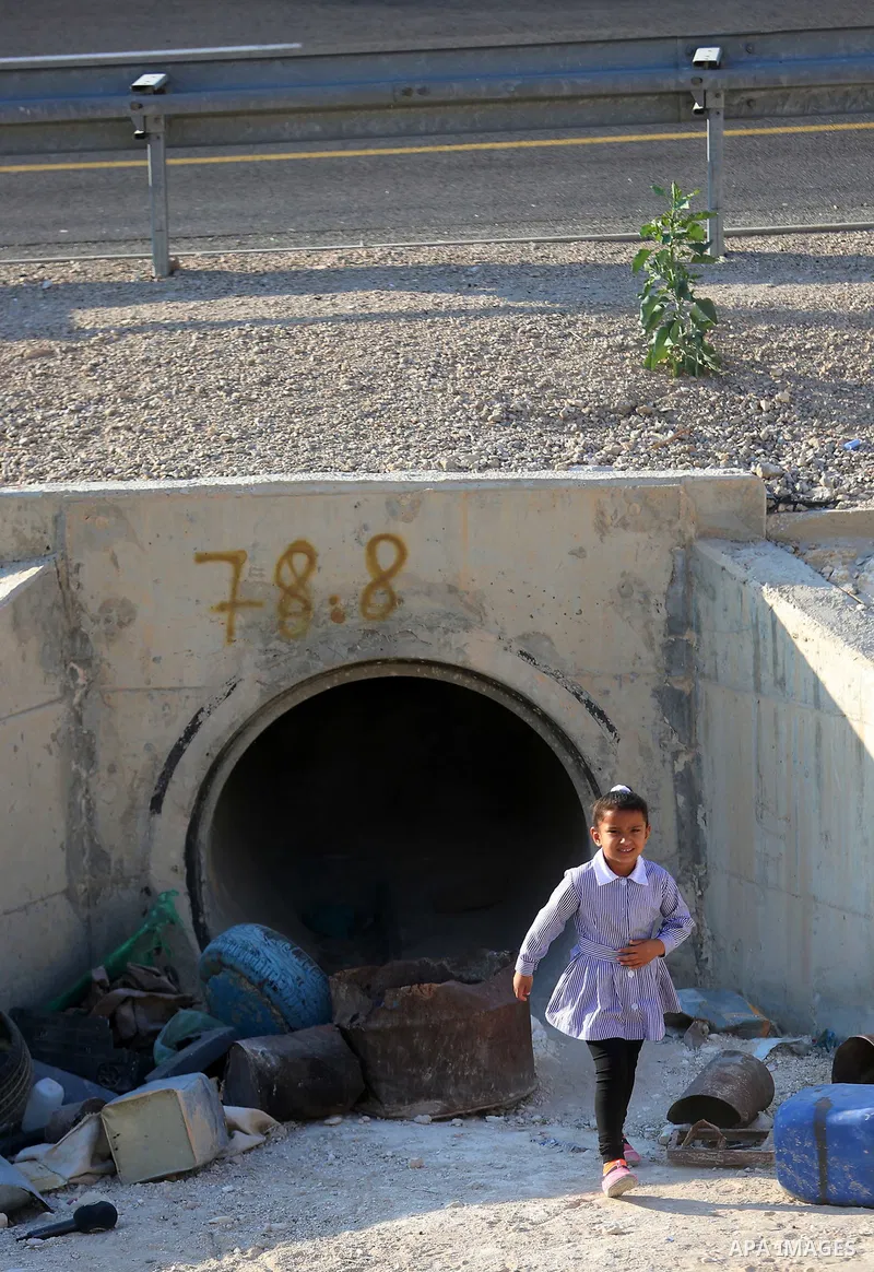 Palestinian schoolchildren return back to their school in the morning of the first day of the new year study, at Khan al-Ahmar's school at the Palestinian Bedouin village of Khan al-Ahmar, east of Jerusalem in the occupi...