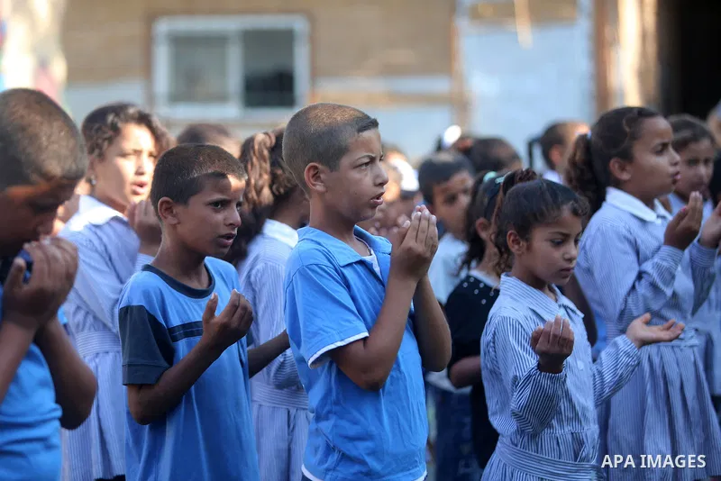Palestinian schoolchildren stand in a line on the first day of a new school year, at Khan al-Ahmar's school at the Palestinian Bedouin village of Khan al-Ahmar, east of Jerusalem in the occupied West Bank on July 16, 201...