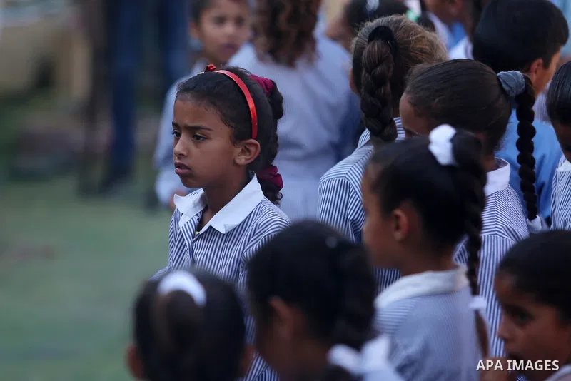 Palestinian schoolchildren stand in a line on the first day of a new school year, at Khan al-Ahmar's school at the Palestinian Bedouin village of Khan al-Ahmar, east of Jerusalem in the occupied West Bank on July 16, 201...